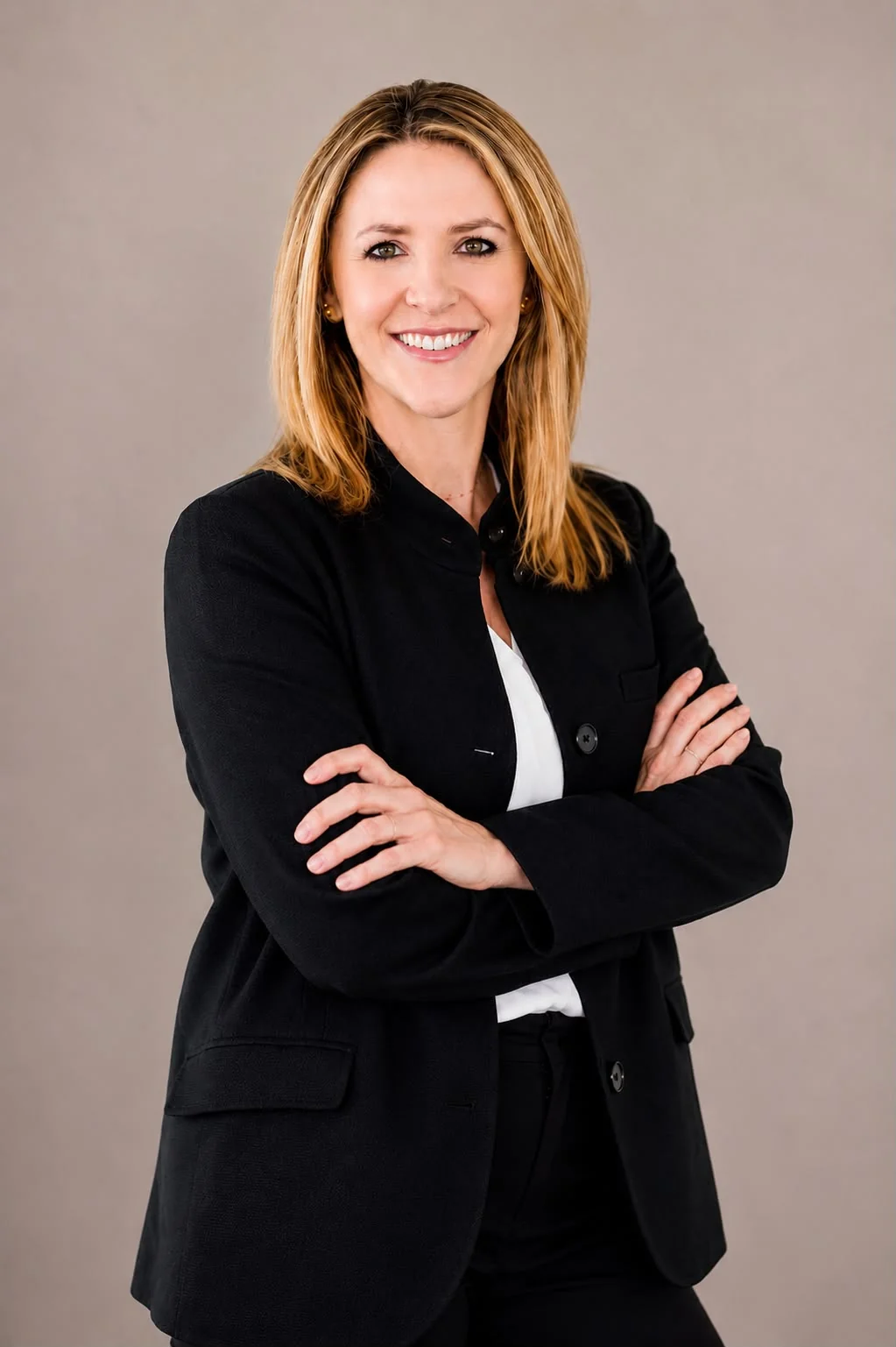 Carina Morris, Houston Realtor, in a dark suit with her arms crossed