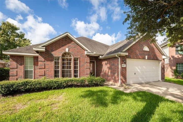 Single-story brick home with a wide front lawn on Rathford Court